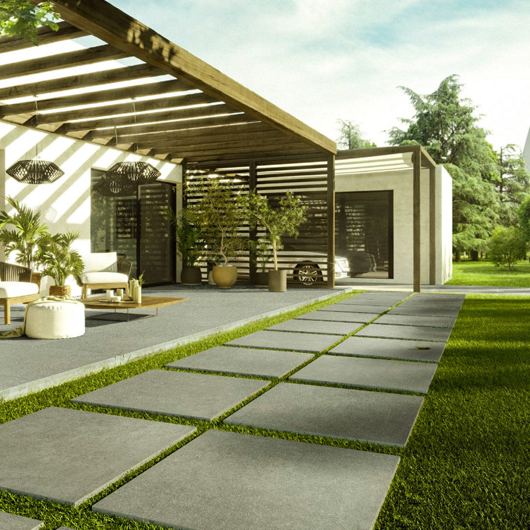 Modern outdoor patio with stone pavers and artificial turf