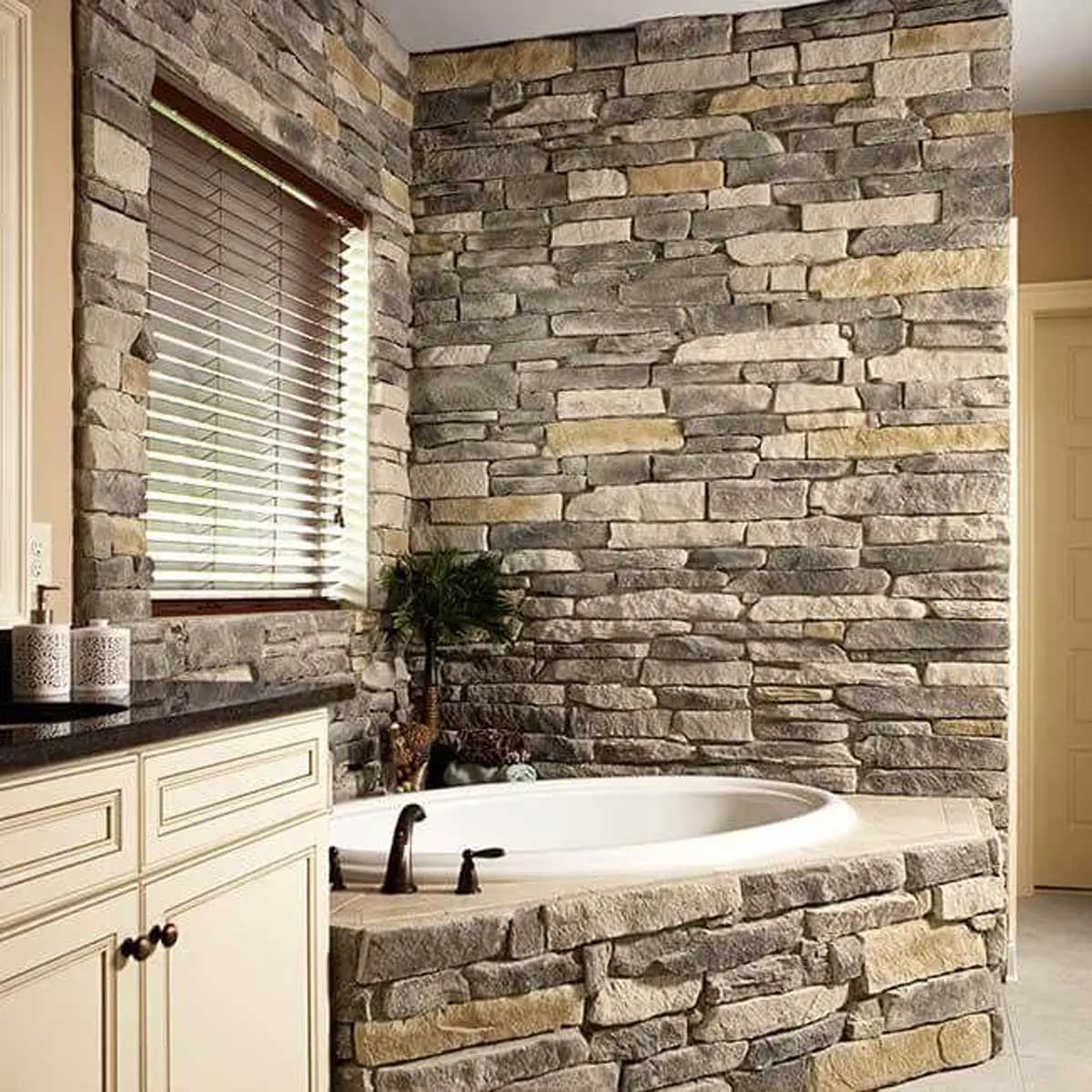 Bathroom bathtub with stone walls