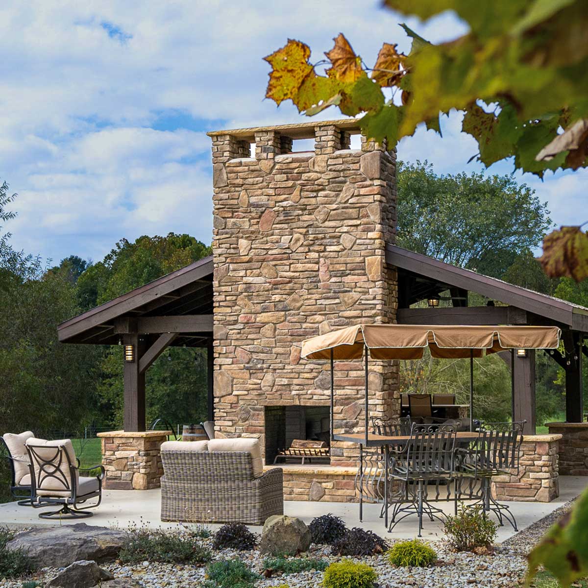 Outdoor patio area with stone veneer fireplace